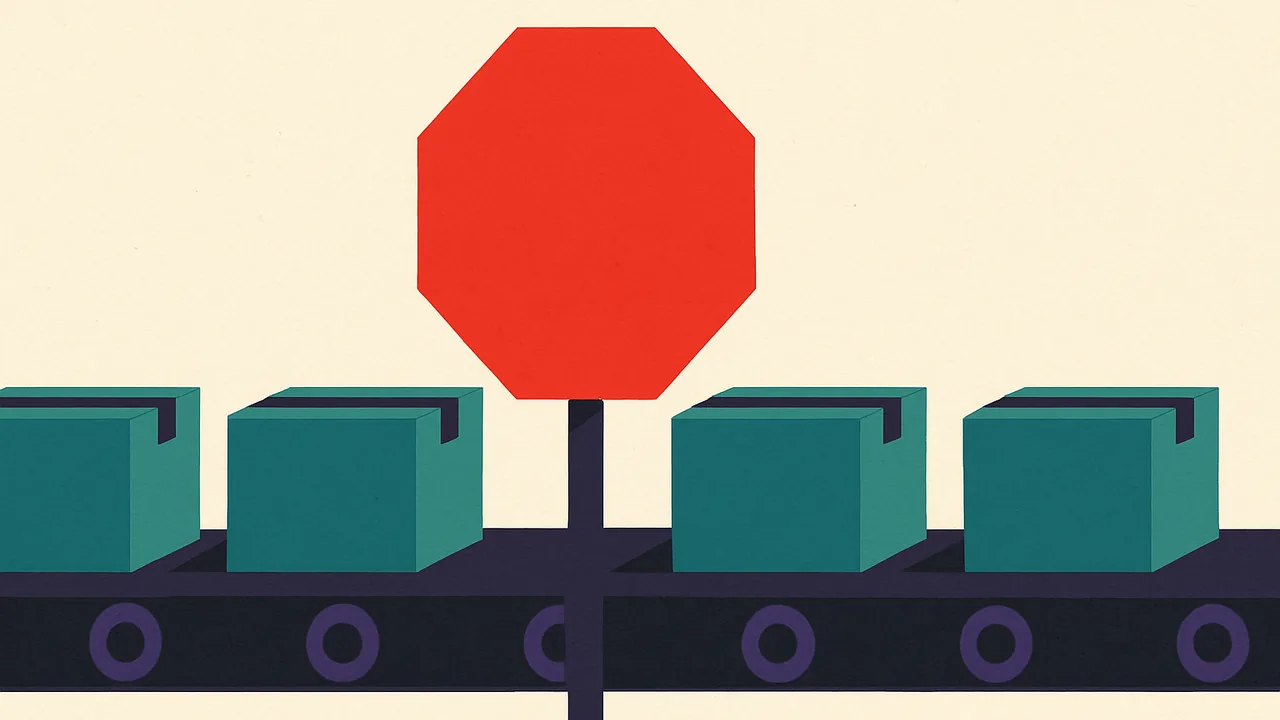 a bright red stop sign blocking a moving conveyor belt carrying identical sealed boxes